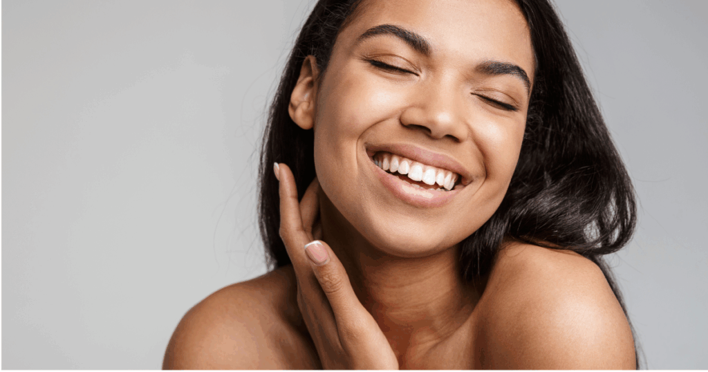 Smiling woman with glowing skin after moisturizing to prep for a Chic la Vie Medical Spa treatment in Las Vegas, showing healthy, radiant results from expert skincare and aftercare.